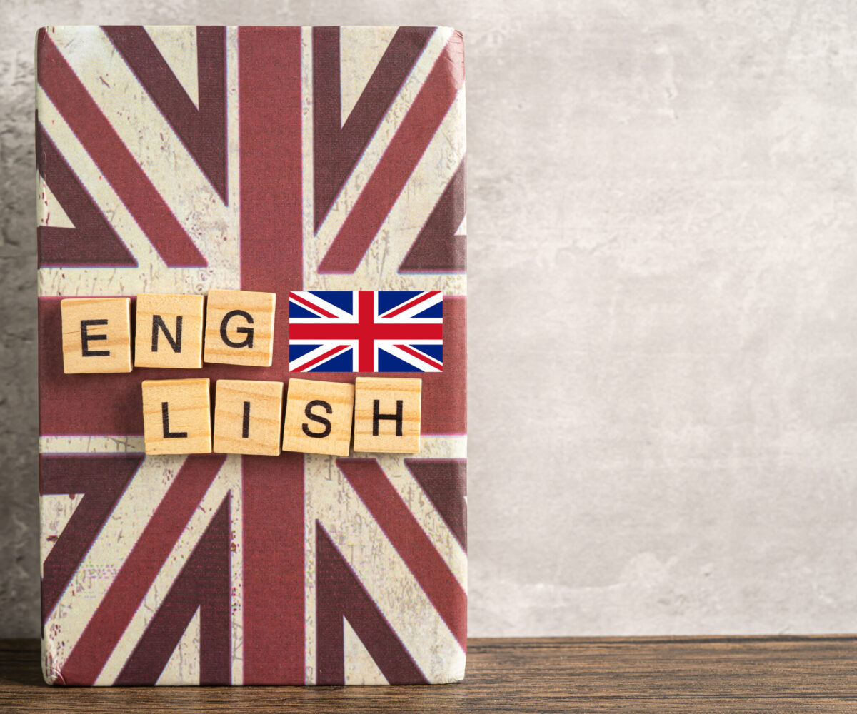 Word English on book with United Kingdom flag, learning English language courses concept.